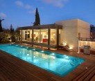 contemporary house with wooden deck and pool
