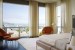master bedroom with floor to ceiling drapery