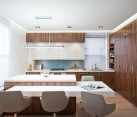 Kitchen with walnut-veneered cabinetry and white furniture