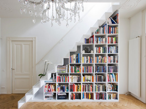 Contemporary staircase with minimalist book shelves in all white