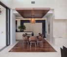 Beautiful ceiling creates a virtual island of wood to accommodate the dining area