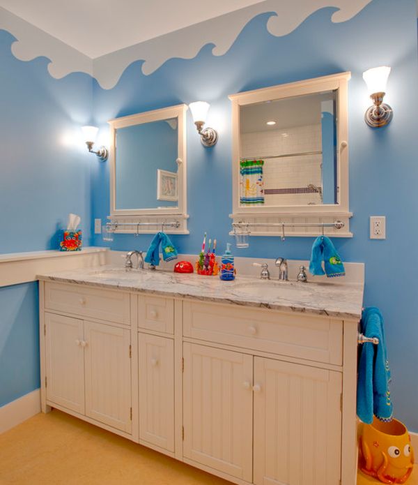Underwater world theme on the walls with unique cabinets turns this bathroom into a world of fun