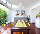 Stylish dining area with sliding glass doors providing access to a small balcony