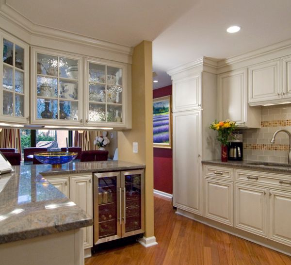 Beautiful frosted glass cabinets and mini beverage cooler fit in aptly in this kitchen