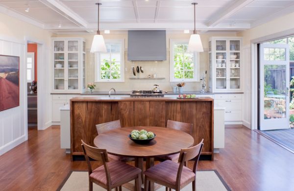 Glass shelves on either side bring symmetry to this kitchen in white