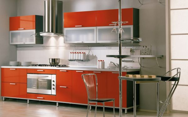 Orange modern kitchen with stylish glass cabinets
