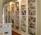 X motif custom designed glass doors give these bookcases an inimitable look