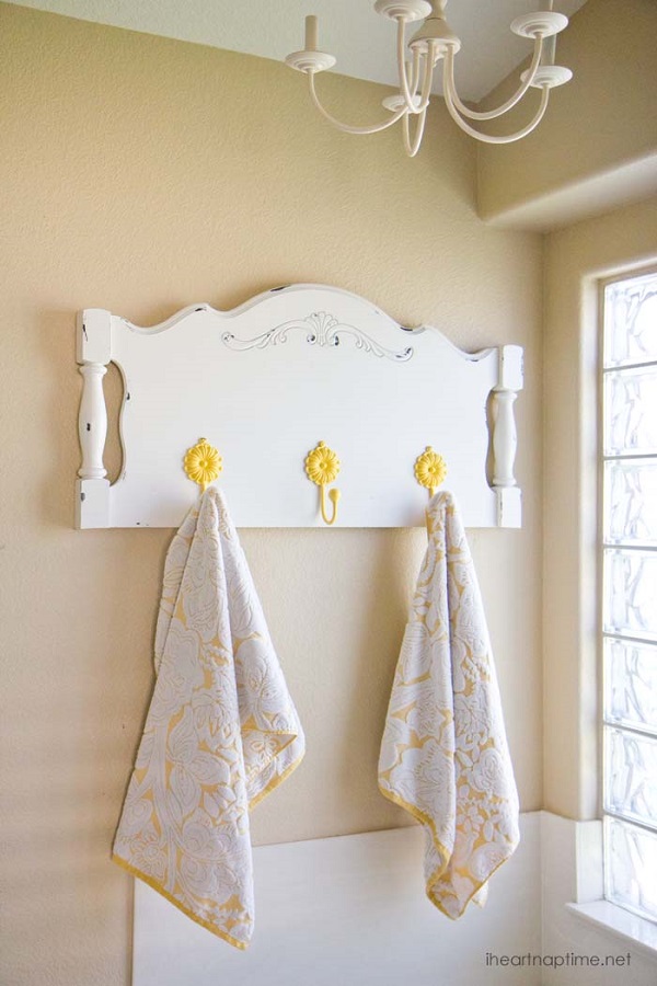 Repurposed headboard towel rack with yellow flower hooks