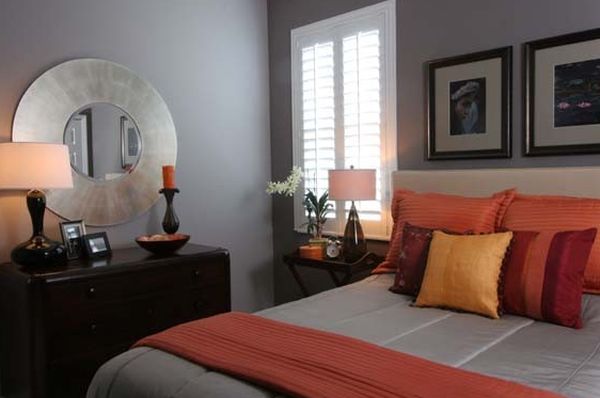 Warm and inviting bedroom in grey with orange accents