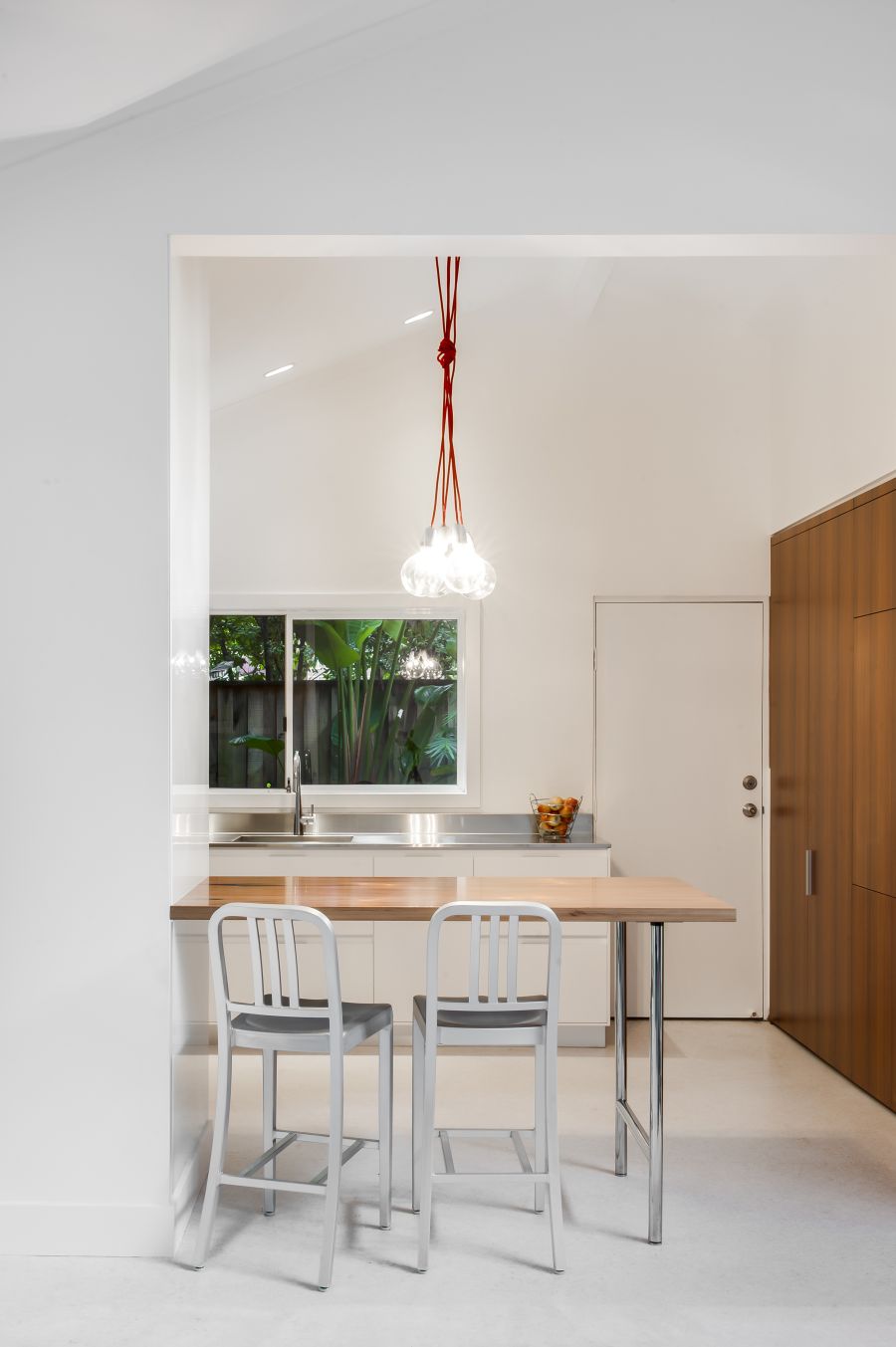 Small Contemporary Kitchen Makes Room For Home Office and Laundry