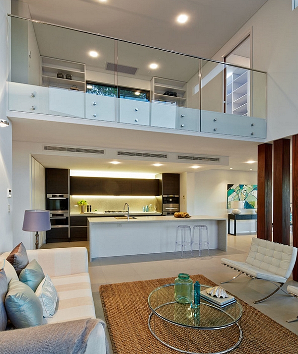 contemporary living room in white with a glass fence for the mezzanine