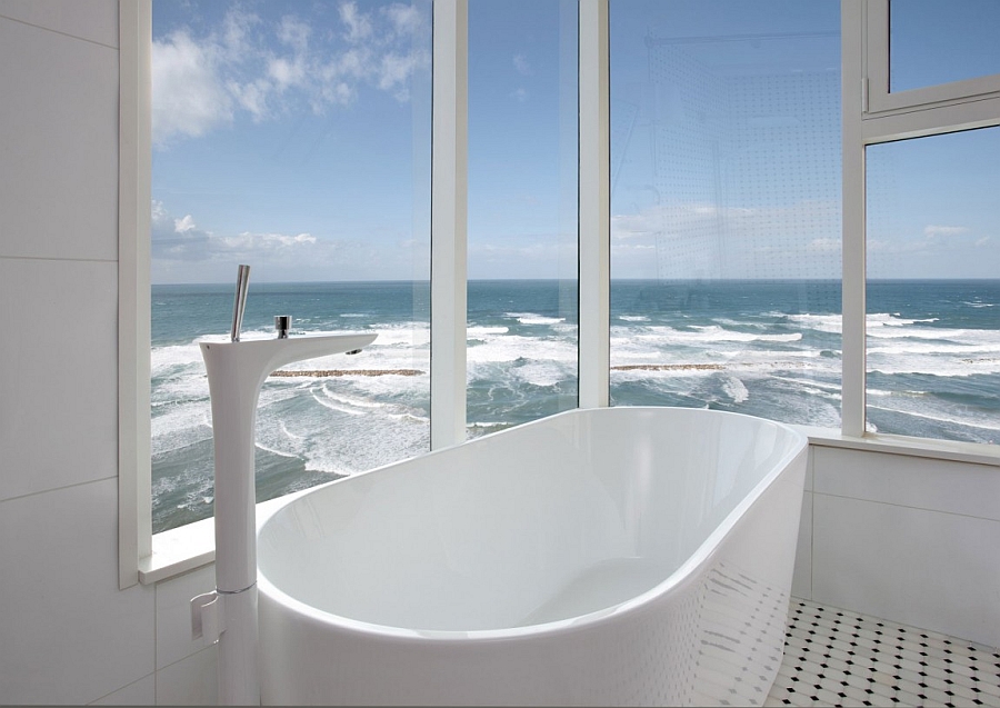 Freestanding tub in the contemporary bath that seems to stand on the edge of the ocean