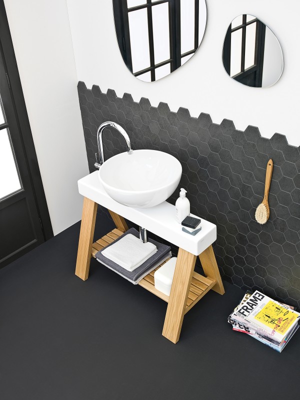 The hip stand below the sink adds a touch of organic charm to the bathroom