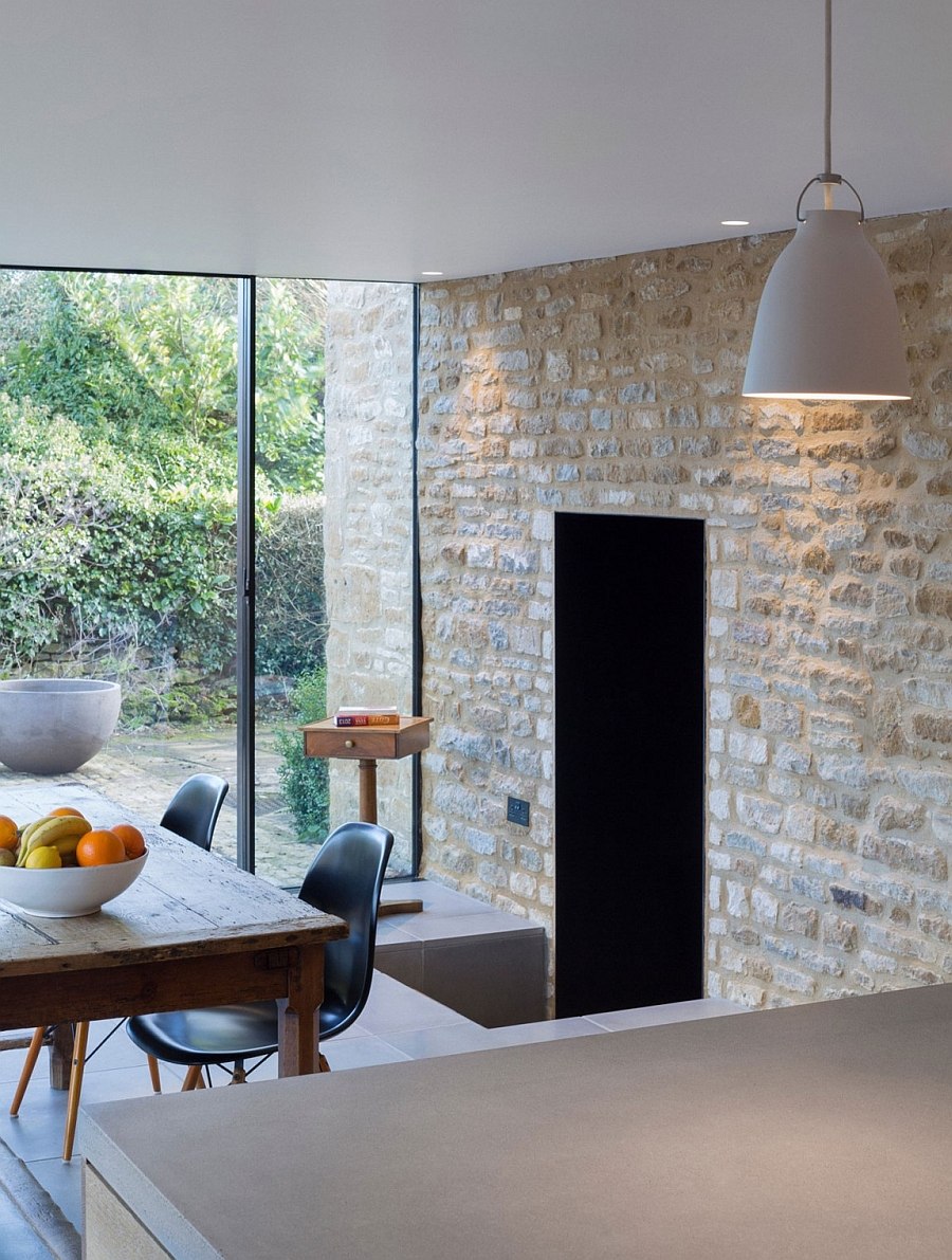 Original stone walls act as the backdrop for the new dining space and kitchen