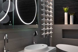 Brilliantly lit contemporary bathroom with unique mirrors and vanity