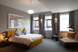Contemporary bedroom with a colorful bed in yellow