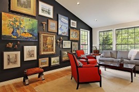 Dramatic gallery wall uses the unique contours of the room to its advantage