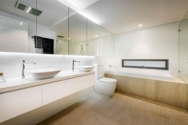 Flooring adds a touch of warmth to the minimal bath