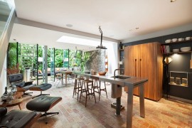Kitchen connected with the patio outside features twin Eames Loungers