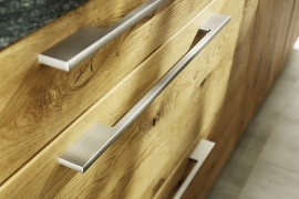 Metal handles complement the hand-sorted wooden surfaces of the Loft kitchen