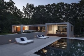 Pool area offers a relaxed spot surrounded by lush green vegetation