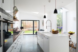 Sliding glass doors connect the kitchen with the backyard