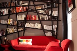 Snazzy bookshelf draws your attention instantly despite bright red decor!