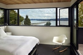 View of the lake in the distance from the cozy, modern bedroom