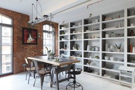 Arched metal windows and brick walls usher in the industrial charm