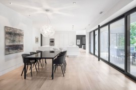 Dining table and chairs in black bring visual contrast to the home