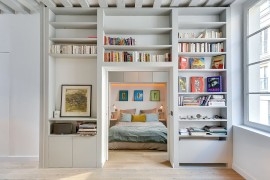 Entry of the bedroom goes through the library wall feature