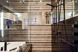Exquisite use of glass gives the small bathroom a spacious appeal