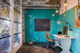 Fabulous industrial style home office with as splash of blue