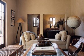 Large globe in the corner combines with the tripod lamp to bring visual symmetry