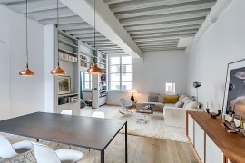 Painted ceiling beams add to the classic appeal of the small apartment