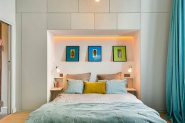 Recessed nook adds additional storage and display options to the small bedroom