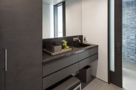 Sliding glass doors connect the bathroom with the bedroom