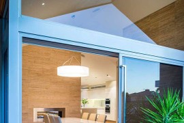 Sliding glass doors connect the dining area with the outdoors