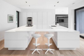Twin kitchen workstations with a suspended breakfast bar