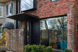 Brick and glass exterior of the renovated Toronto home