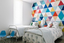 Fabulous wallpaper adds color and pattern to the cool kids' bedroom