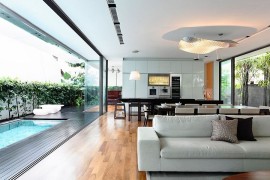 Living area of the lovely Singapore home connected with the deck space outside