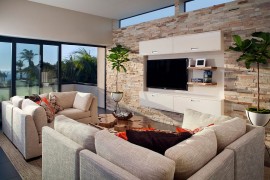 Lovely use of bullet planters in the stylish living brings visual symmetry