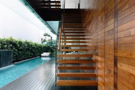 Sleek floating staircase connects the private deck with the master bedroom above