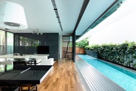 Sliding glass doors connect the interior with the courtyard and lap pool outside