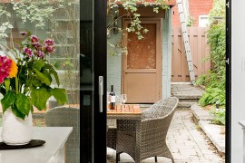 Sliding glass doors connect the kitchen with the backyard