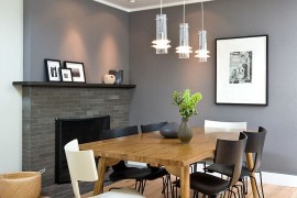Stylish chairs and a gorgeous gray backdrop shape the contemporary dining room