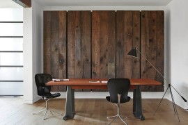 Wooden panels conceal a large Murphy bed behind them in this contemporary home office