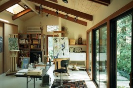 Art studio and home office connected with the outdoors through glass doors