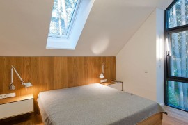 Bedroom on top floor overlooking the forest landscape outside